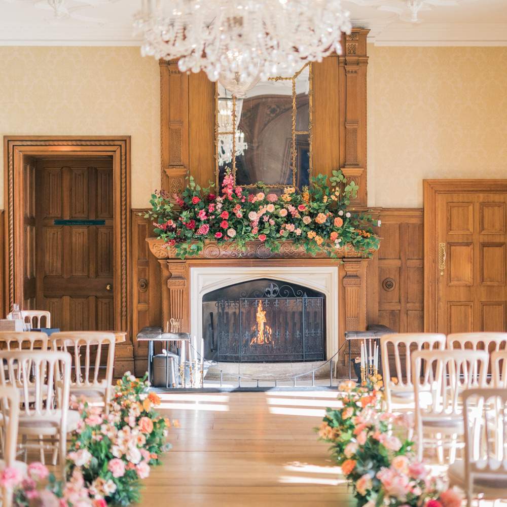 Indoor civil ceremony setup in Froyle Park's Great Hall. This space can seat up to 140 guests and has a number of original Jacobean features, including a working fire place, crystal chandeliers and beautiful wood panelling. Ideal for cosy Winter weddings.