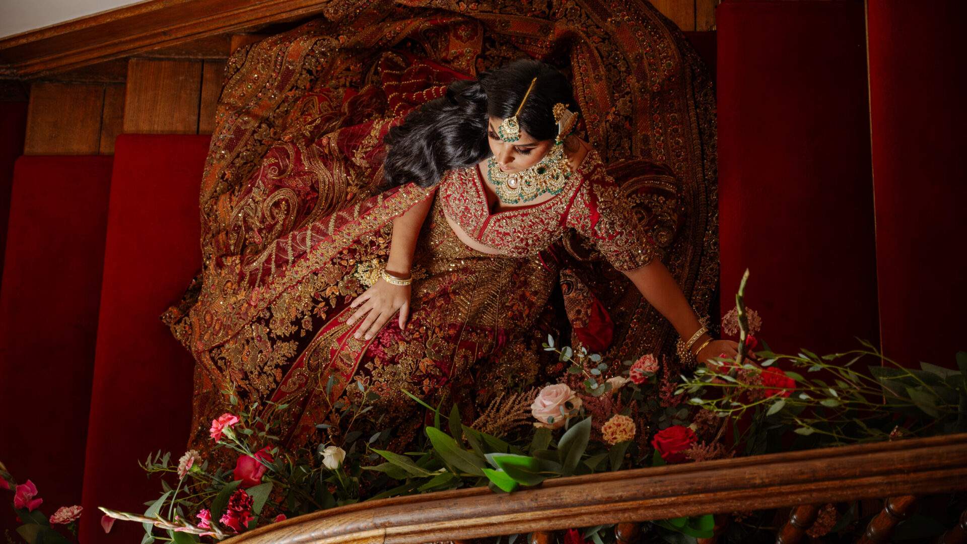 A Bride on Froyle Park's red staircase in the Great Hall.