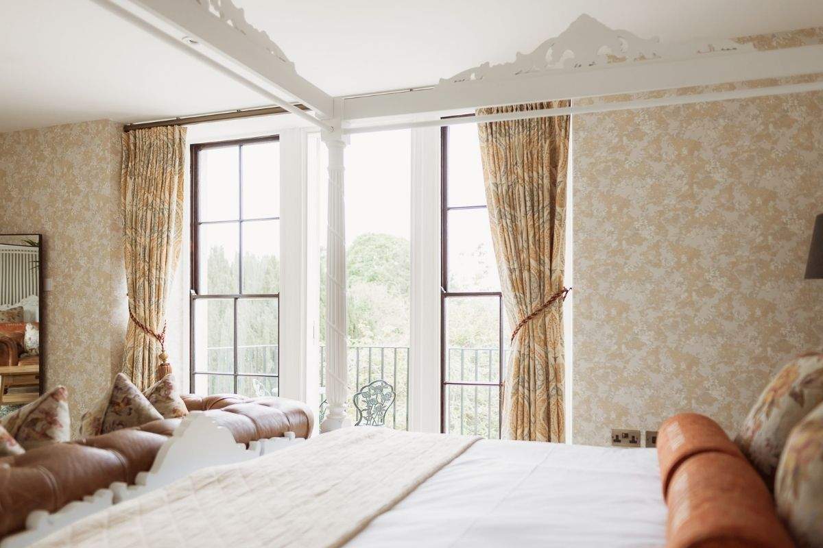 Four-poster bed in the Honeymoon Suite at Froyle Park, a romantic wedding night stay in Surrey