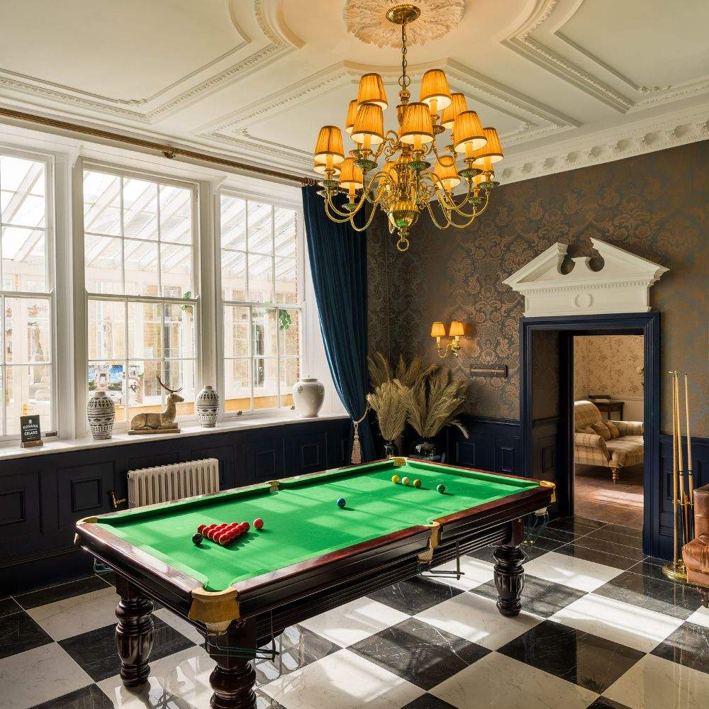 The Groom's Lounge is a getting ready space that benefits from a snooker table and decadent decor