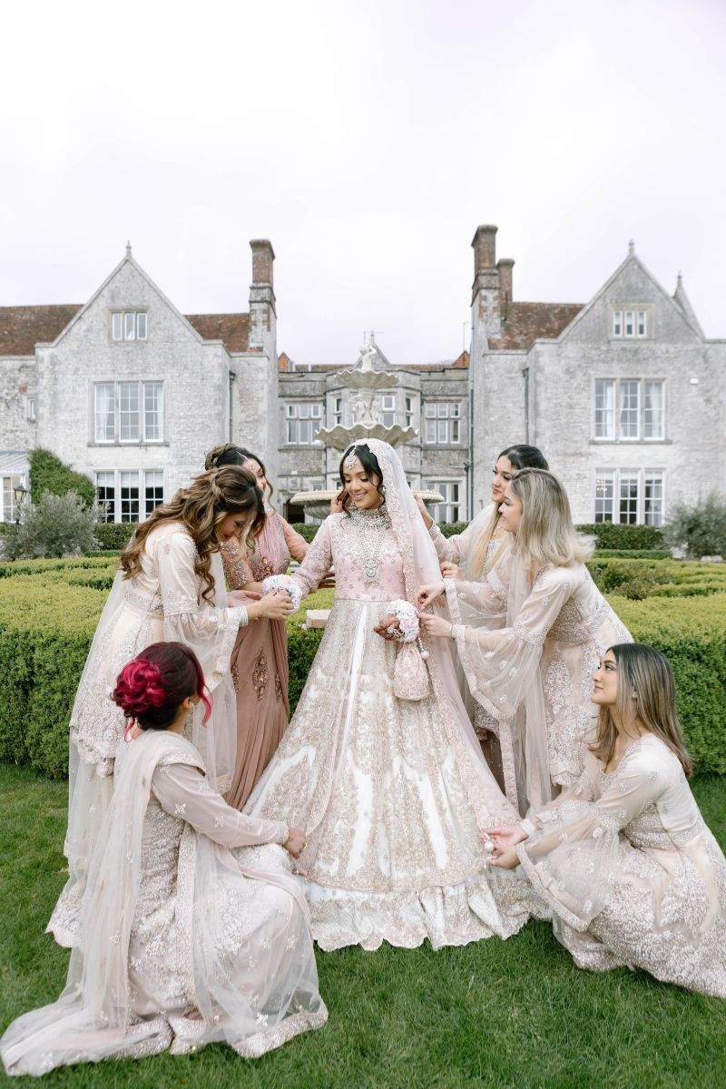 A Muslim bride being attended to in the grounds of Froyle Park, a Pakistani wedding venue near London