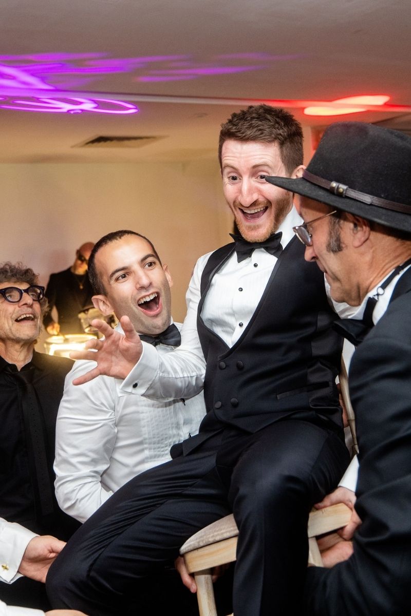 A groom is ready to be lifted for the Hora at Froyle Park